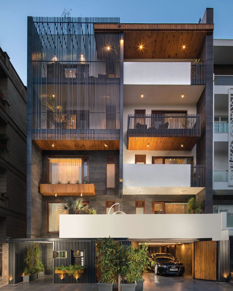 Nadora by Ritu Gupta The façade features grey tiles, pine wood paneling