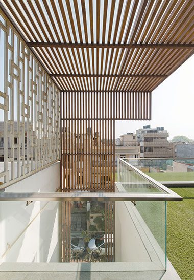 Wooden louvres in semi open terrace area - J House