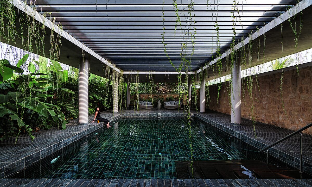 Antriya swimming pool beneath a planted pergola